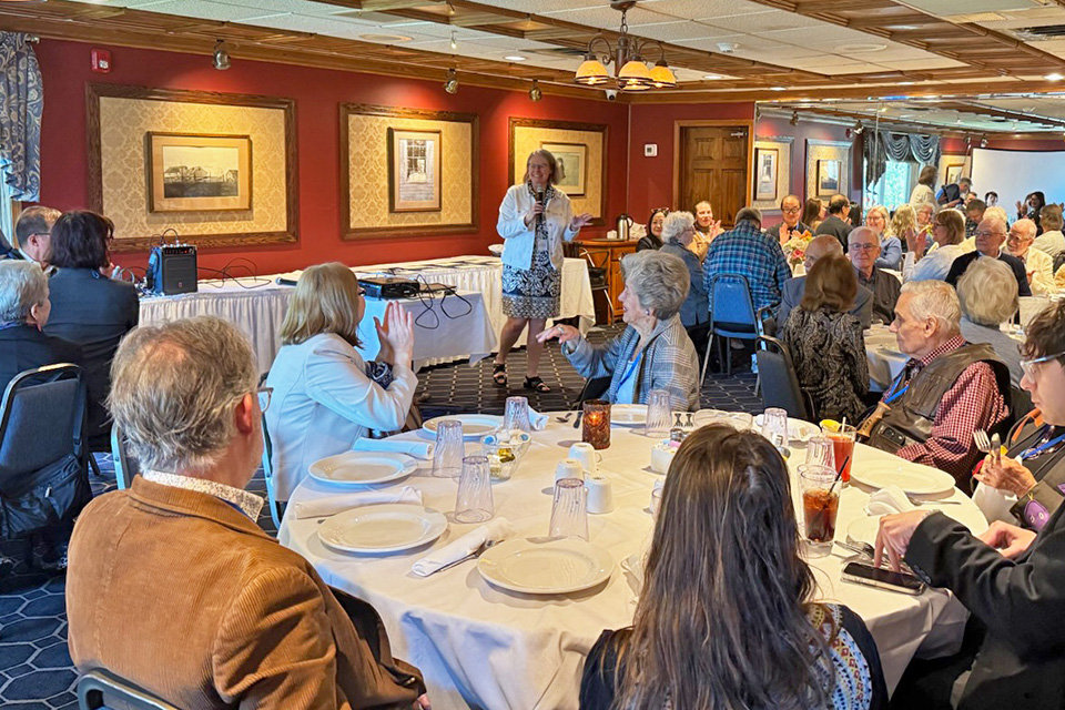 Chicago Section Chair Amy Balija as emcee, celebrating anniversary milestones