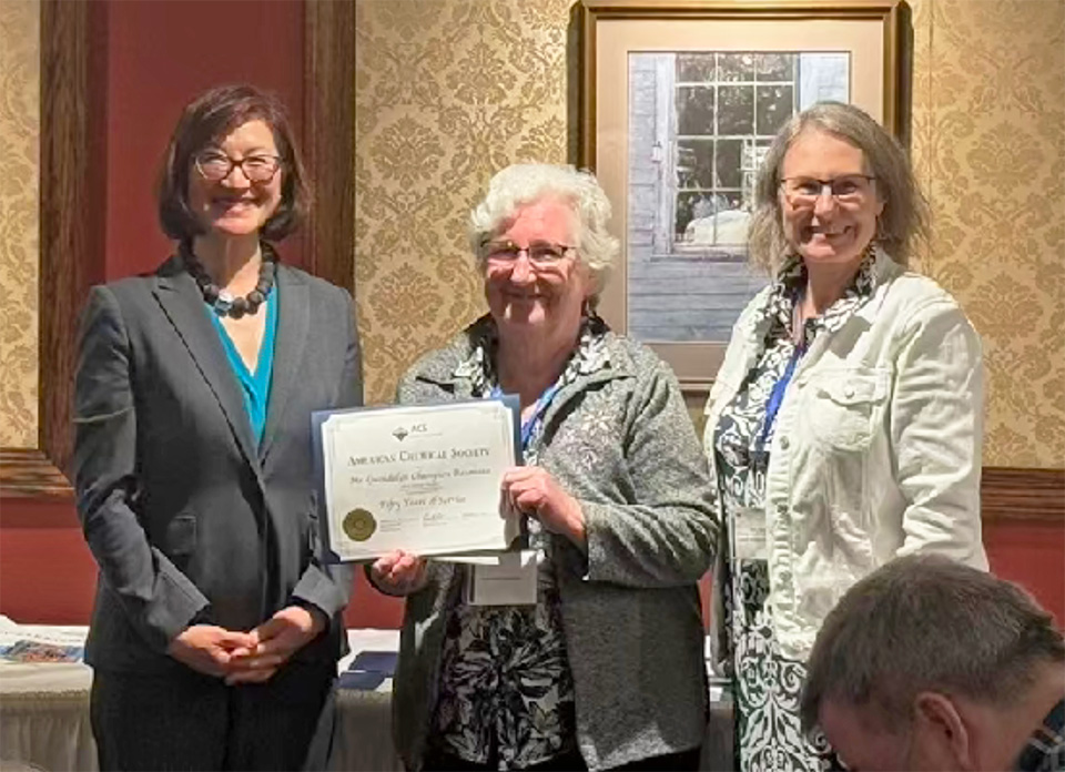 50-year ACS member Gwendalyn Champion Baumann (center) receives her award from Katherine Lee (L) and Amy Balija (R)
