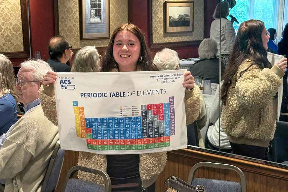 Anna DeFilippi, daughter of 50-year ACS member Louis DeFilippi, enjoying her periodic table door prize