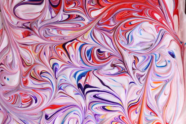  Food coloring marbled into shaving cream.