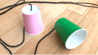 image of materials needed to make a string telephone: two plastic cups attached together sat their bases with string