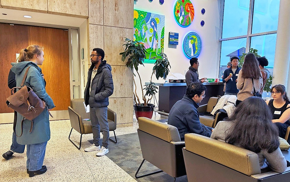 Photo of younger chemists in Loyola's Quinlan Hall lounge, conversing prio to the main Chicago ACS meeting