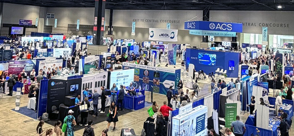 Photo of the ACS Fall 2026 Expo, taken from an elevated position to one side to show many booths and attendees