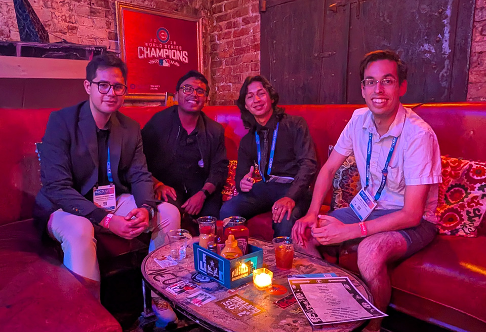Photo of four people at a low table in a fun bar/restaurant