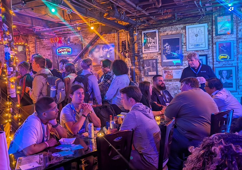 Photo of a crowd of people, some seated, in a fun bar/restaurant