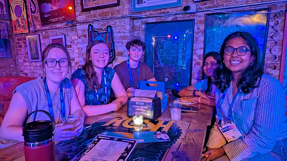 Photo of four people at a low table in a fun bar/restaurant