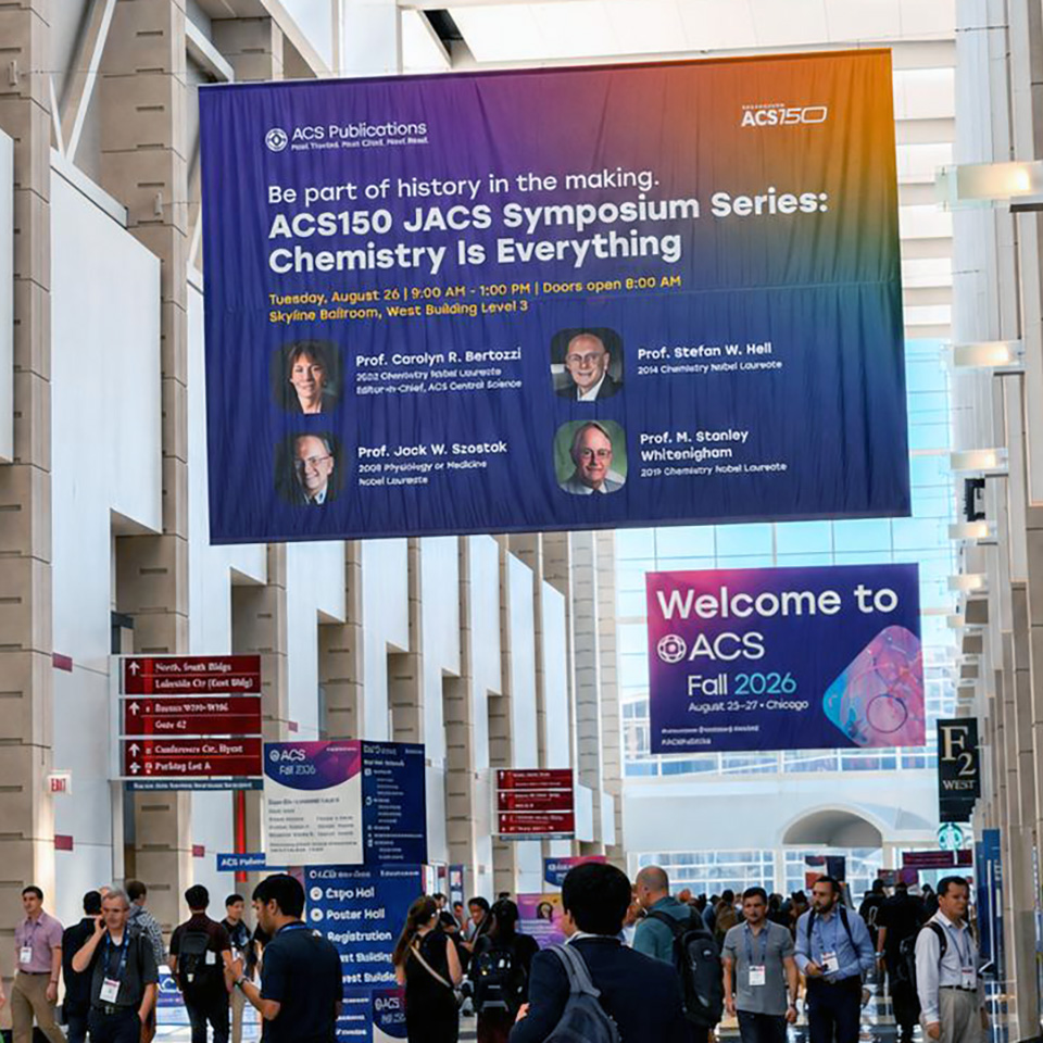 photo of banners inside a main hall of the ACS Fall 2026 meeting. One prominently shows the JACS symposium speakers